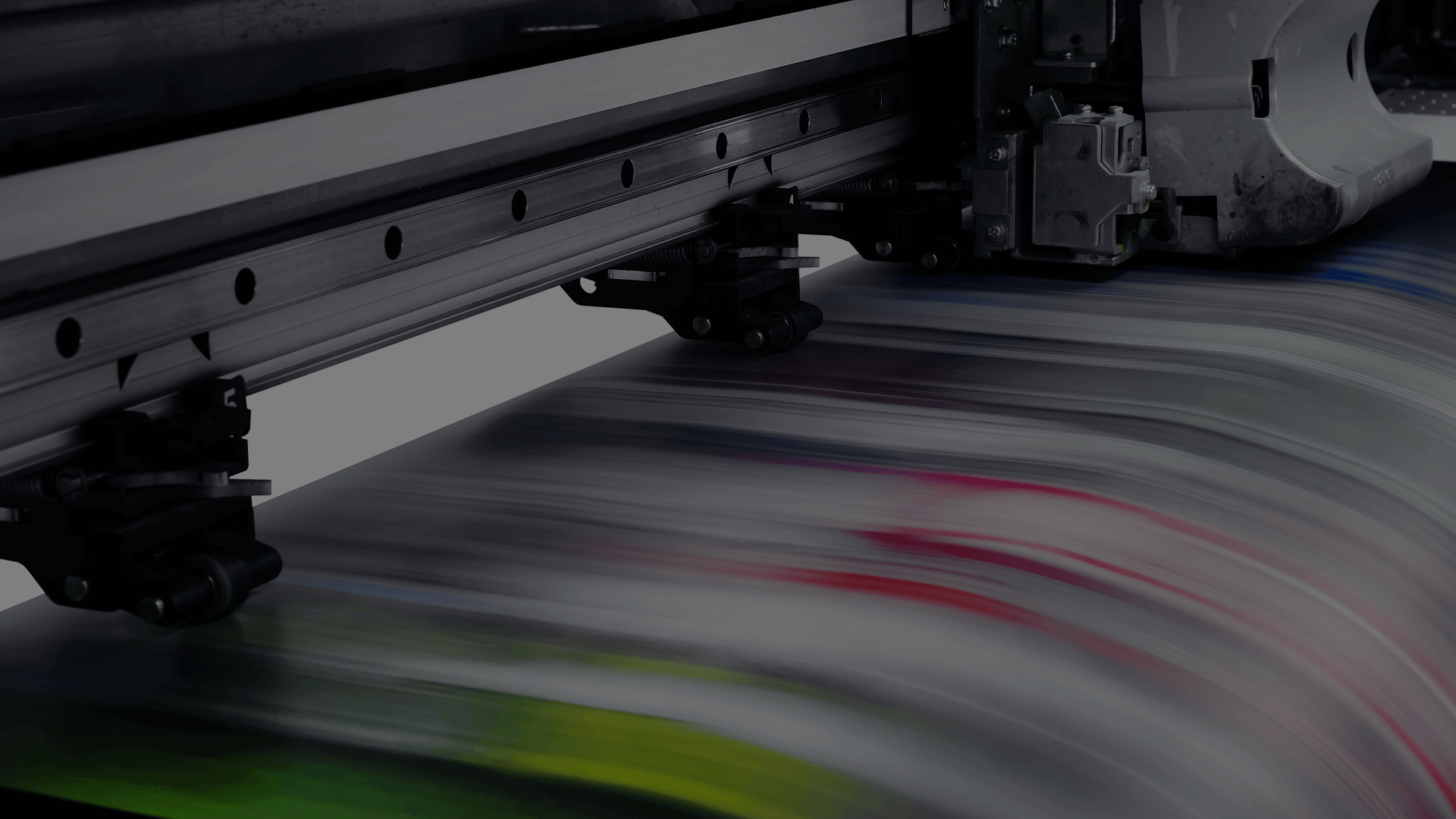 Managed Print Services: An Essential Guide for Businesses A high-speed, wide-format printer producing vibrant, colorful prints, emphasizing the capability and efficiency of advanced managed print services.