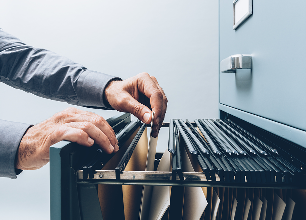 Document Digitization for the Public Sector: Person rifling through filing cabinet