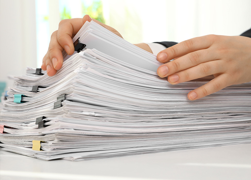 Digital Filing Cabinet: Person leafs through stack of paper files