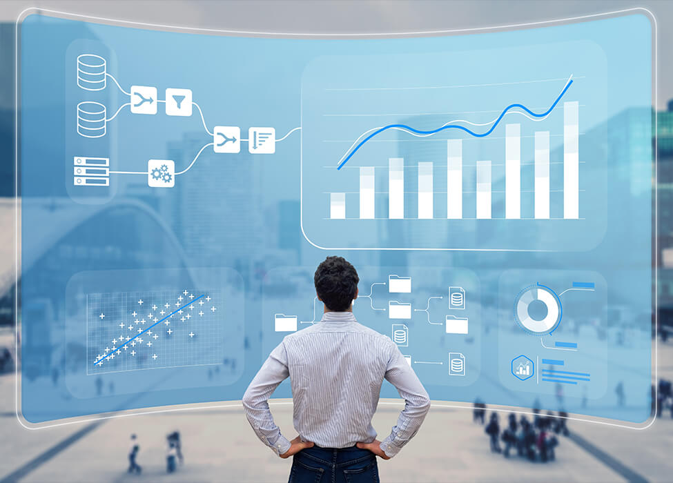 A person analyzing complex data visualizations and charts on a transparent screen, representing the integration of hyperautomation in data-driven decision-making processes.