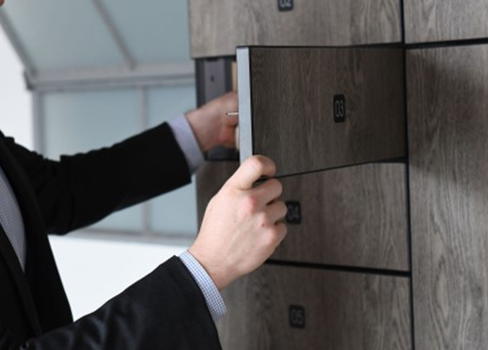 Office worker opening a locker in Exela's smart locker systems