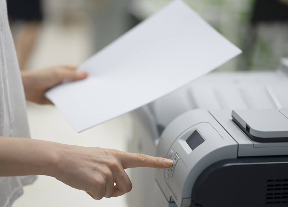 Close up of a person clicking the button on a scanner to scan something