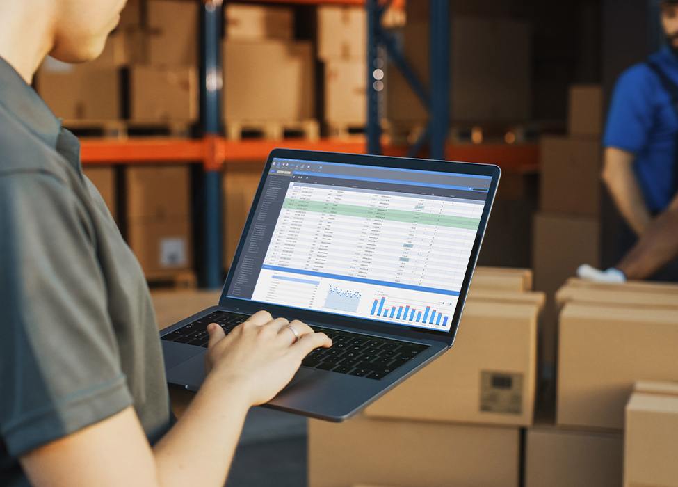 Smart Technology | Worker in warehouse using laptop apps to work