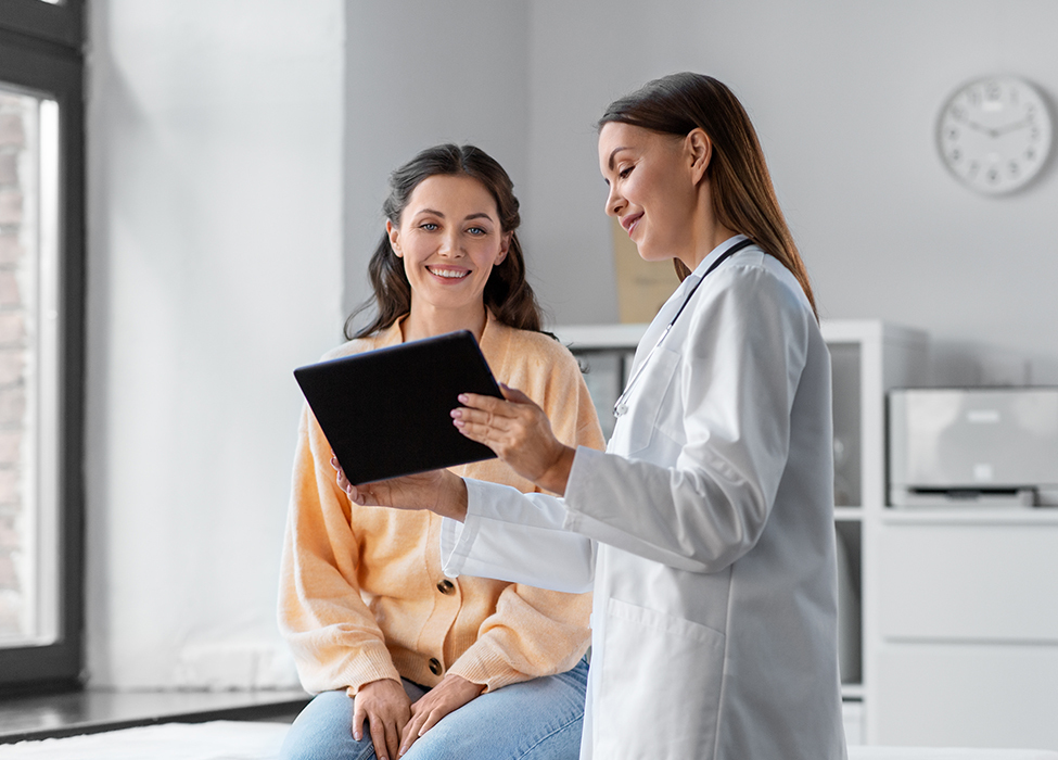 healthcare in automation | doctor showing clipboard to patient and talking to them