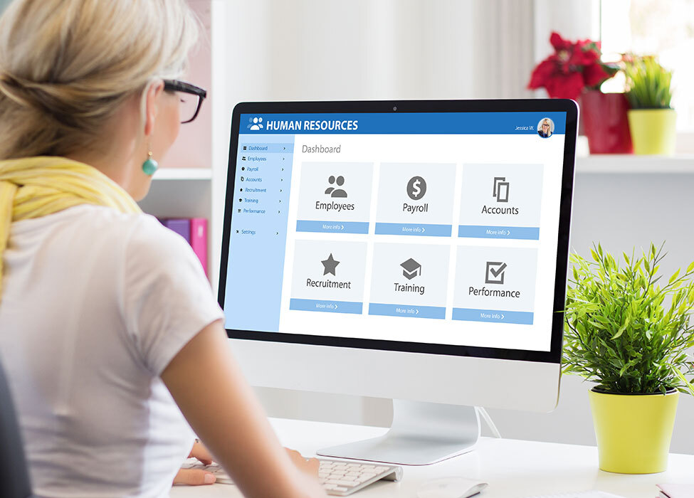 Business Process Automation: Person working on computer with human resources dashboard on screen