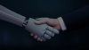A human hand and robot hand shake
