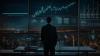 A person in a dark suit stands before a vast array of digital screens displaying complex financial data and graphs. The background showcases a panoramic view of a city at night, with sprawling lights and urban structures, signifying a high-tech, data-driven environment for financial analysis or trading.