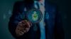 Close-up of a person holding a magnifying glass, focusing on a human icon with a green checkmark, symbolizing the effectiveness of a recruitment strategy. The background features multiple icons of people, highlighting the process of selecting the right candidate.